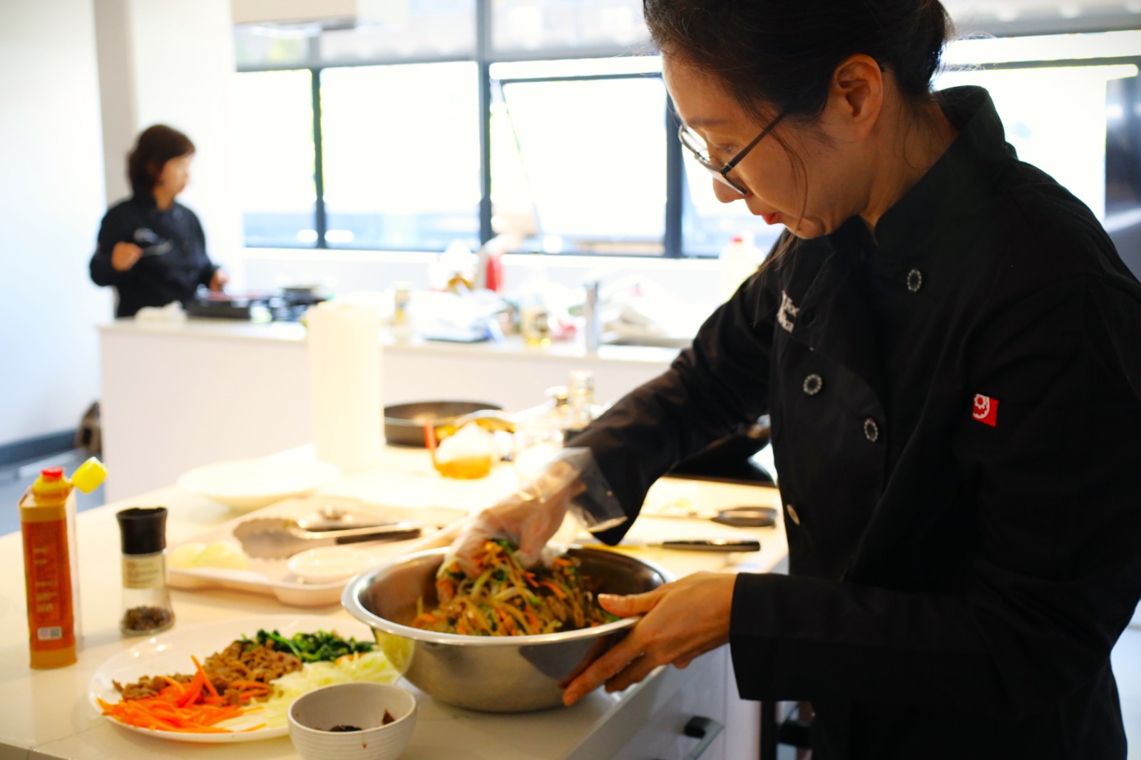 A person preparing food in a kitchen

Description automatically generated