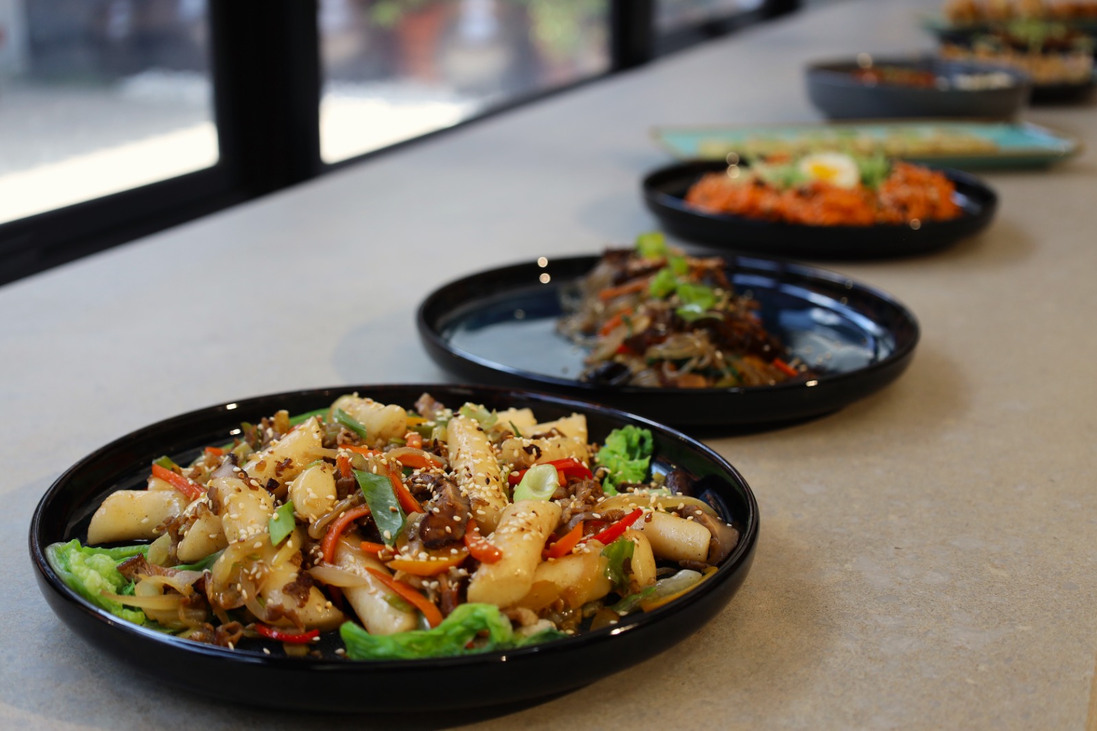 A row of plates of food

Description automatically generated