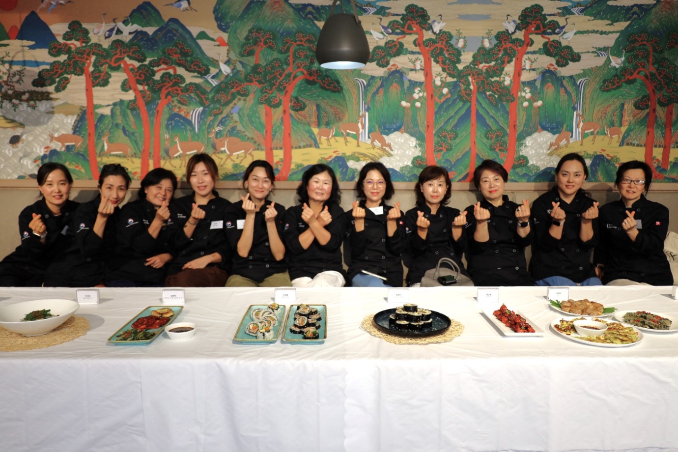 A group of people sitting at a table with food

Description automatically generated