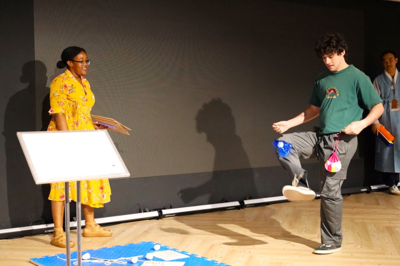 A person and person dancing on a stage

AI-generated content may be incorrect.