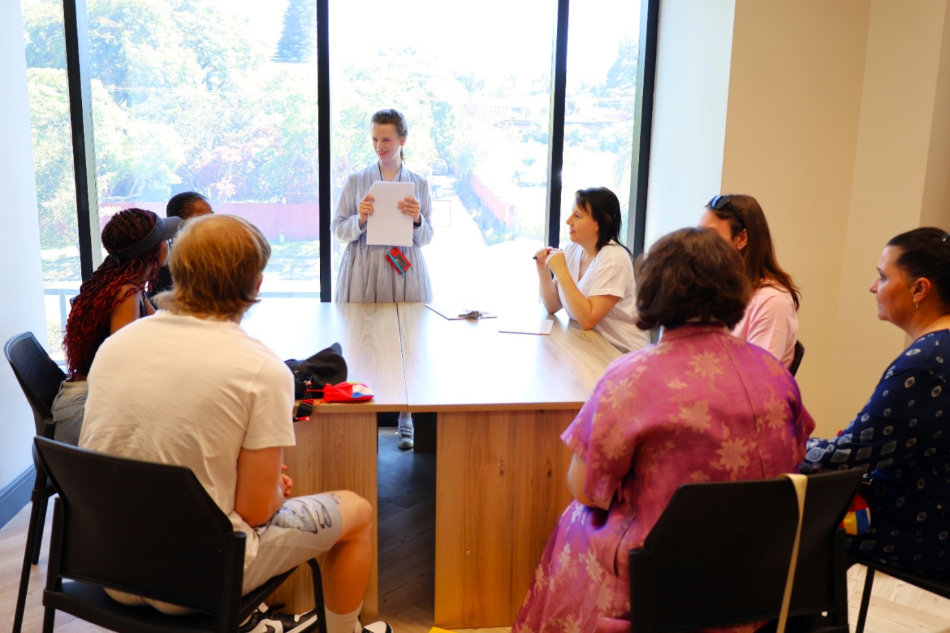 A person standing in front of a group of people

AI-generated content may be incorrect.