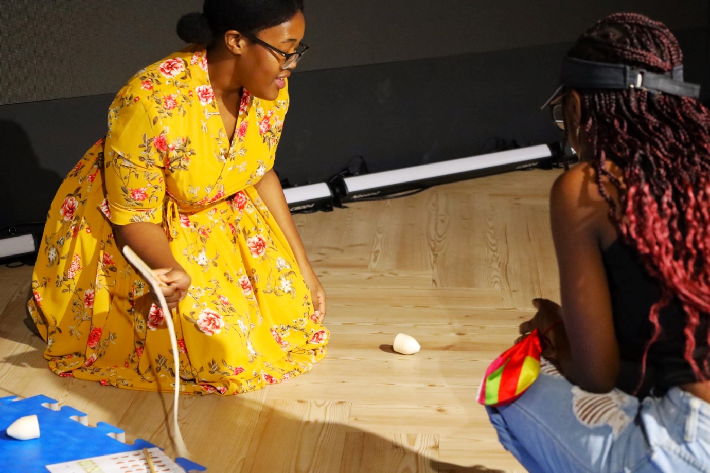 A person in a yellow dress sitting on the floor

AI-generated content may be incorrect.