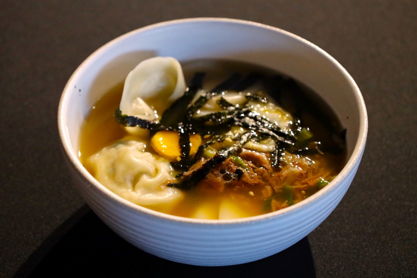 A bowl of soup with food in it

AI-generated content may be incorrect.