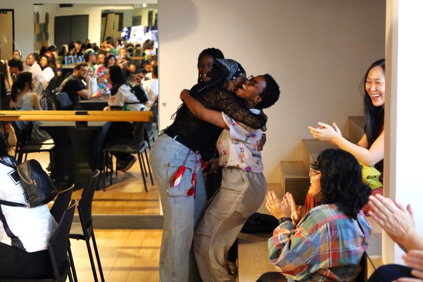 A group of women hugging in a room

AI-generated content may be incorrect.