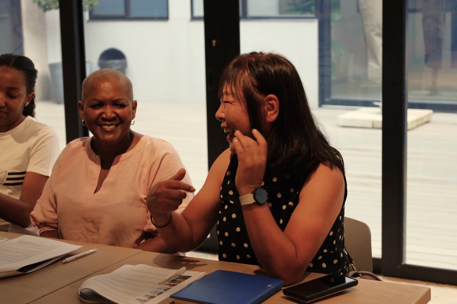 A group of women sitting at a table

AI-generated content may be incorrect.