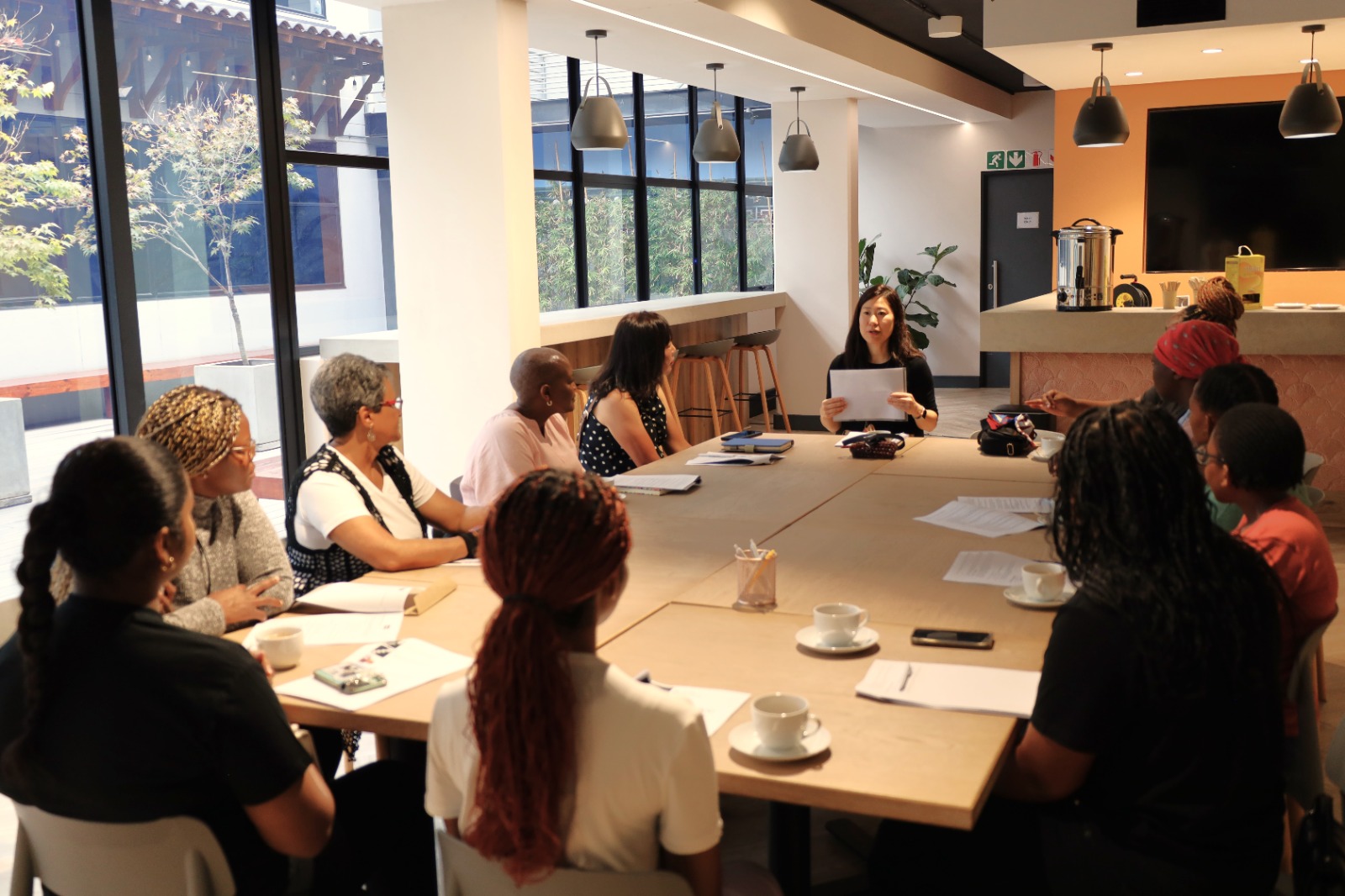 A group of people sitting around a table

AI-generated content may be incorrect.