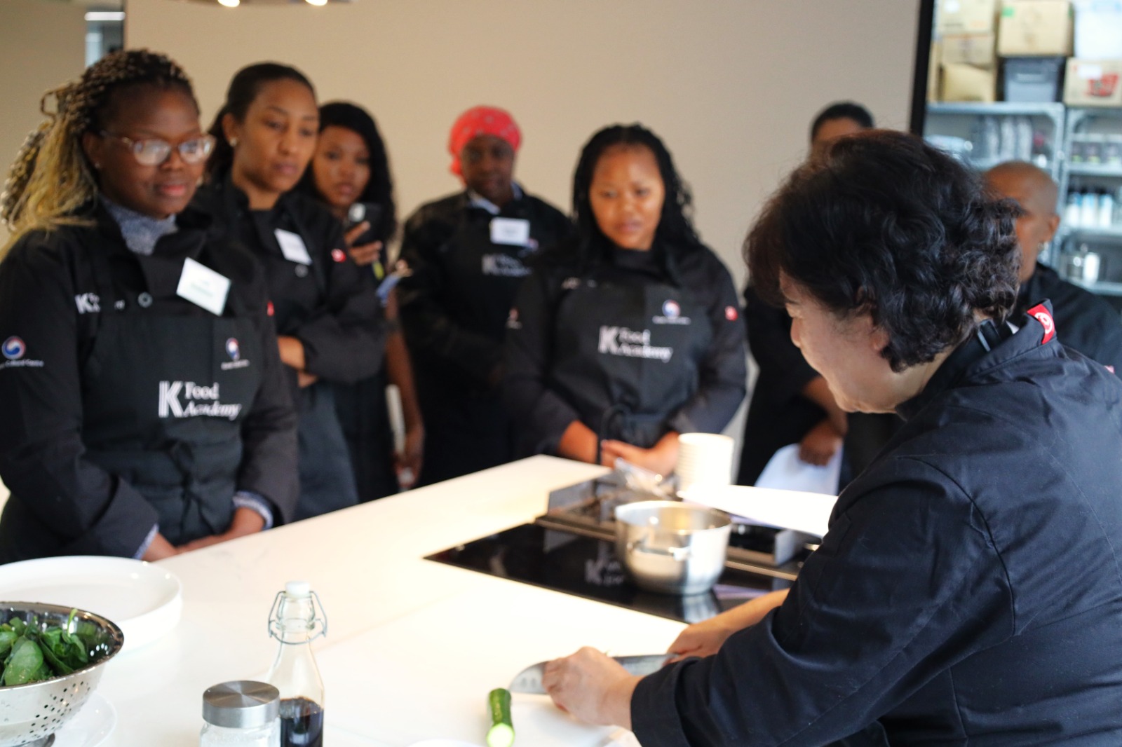 A group of women standing around a table

AI-generated content may be incorrect.