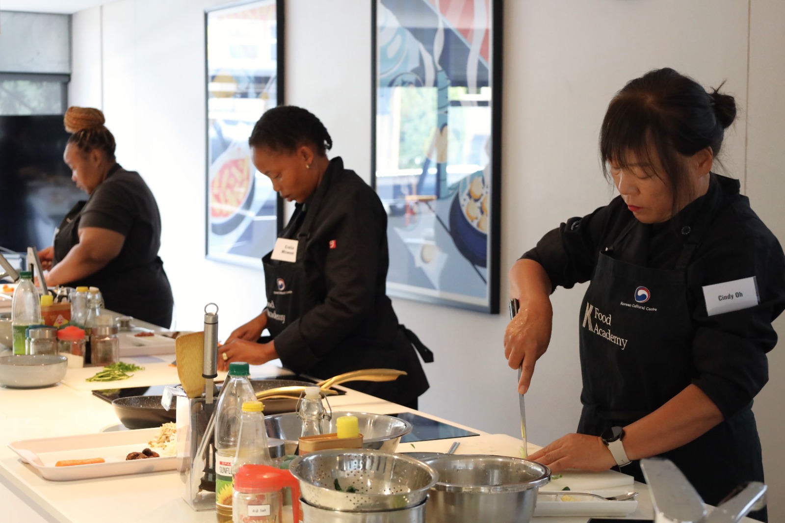 A group of women cooking in a kitchen

AI-generated content may be incorrect.