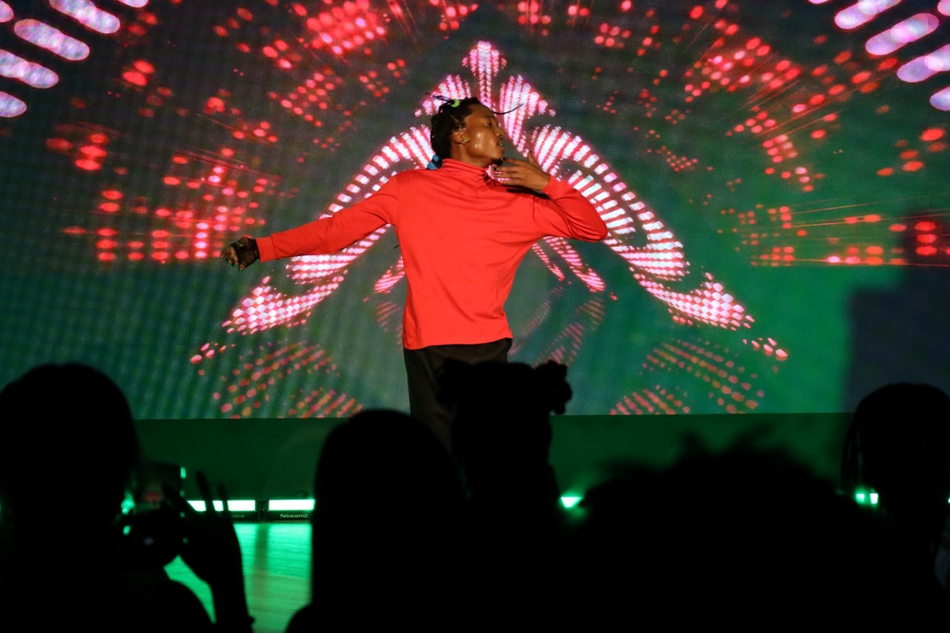 A person on a stage with his arms out

AI-generated content may be incorrect.