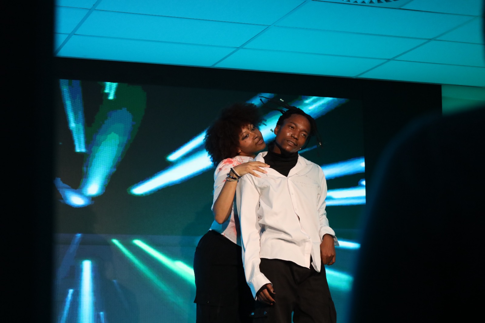 A person and person dancing on a stage

AI-generated content may be incorrect.