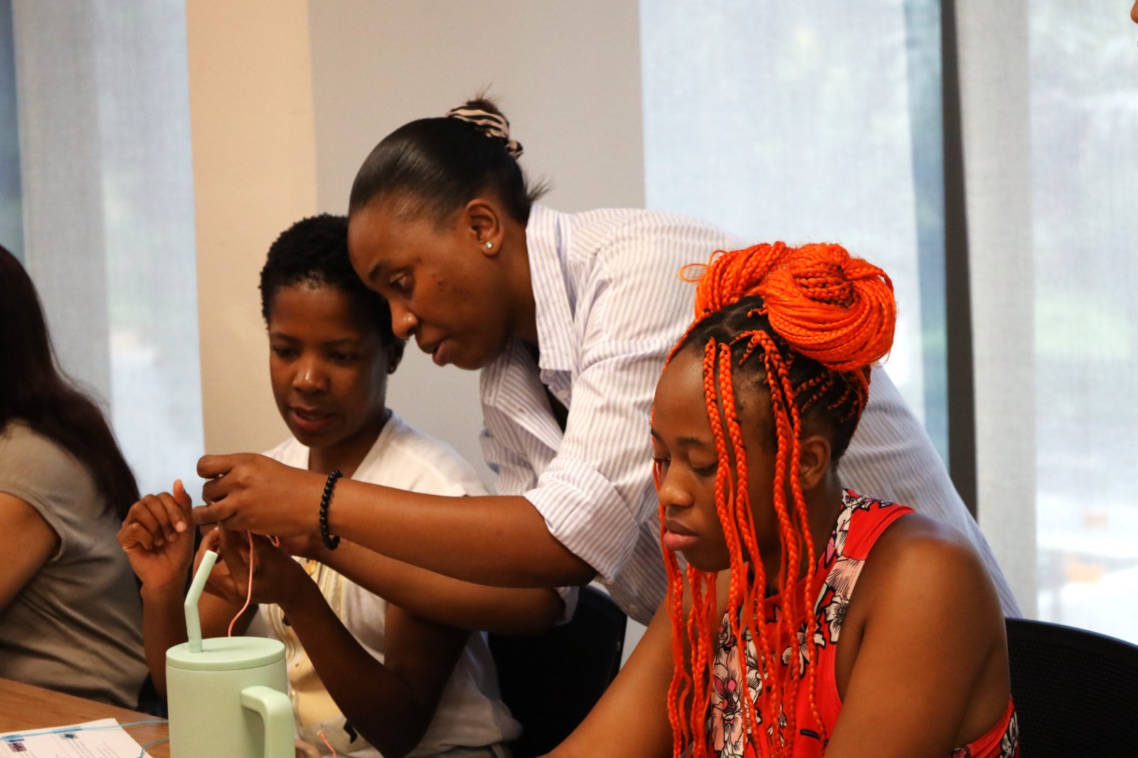 A group of women working on a project

AI-generated content may be incorrect.