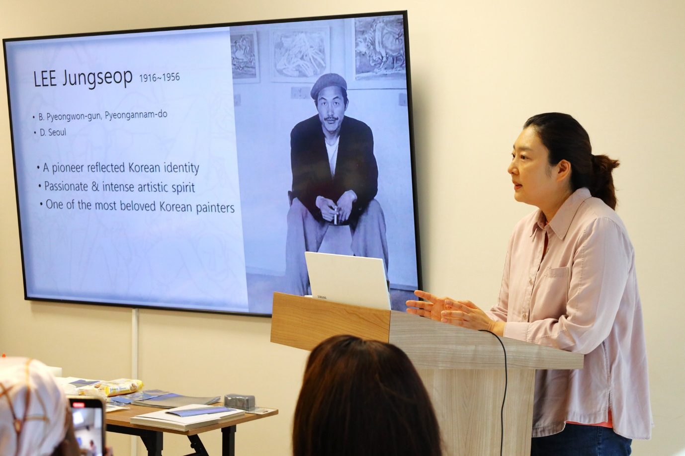 A person standing in front of a screen

AI-generated content may be incorrect.