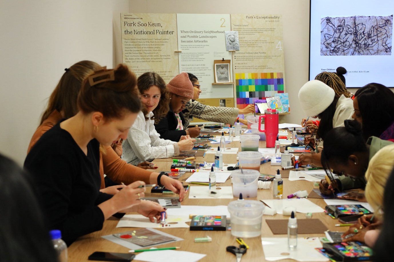 A group of people sitting at a table

AI-generated content may be incorrect.