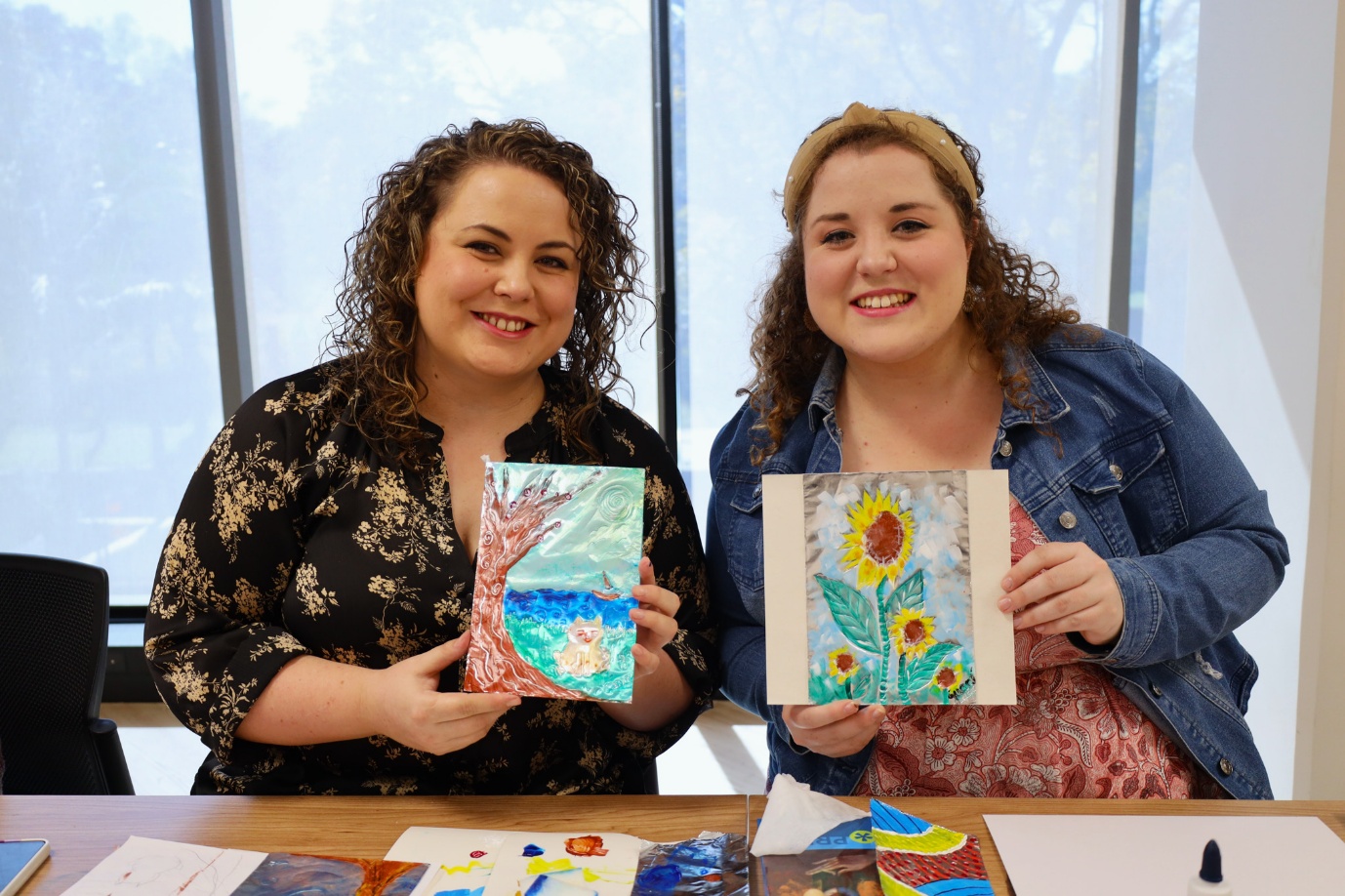 Two women holding up pictures

AI-generated content may be incorrect.