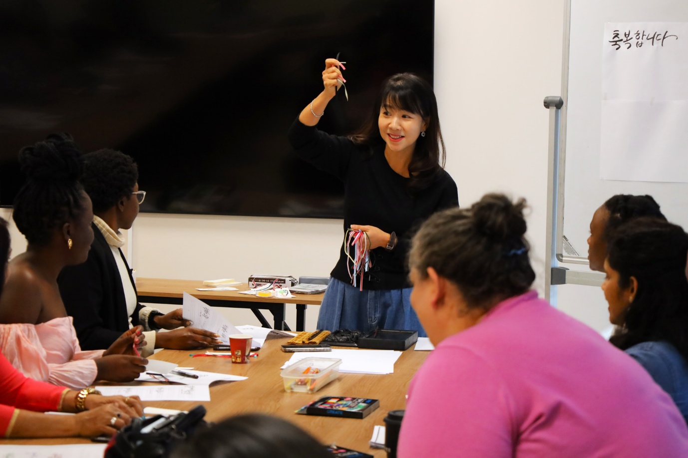 A person standing in front of a group of people

AI-generated content may be incorrect.
