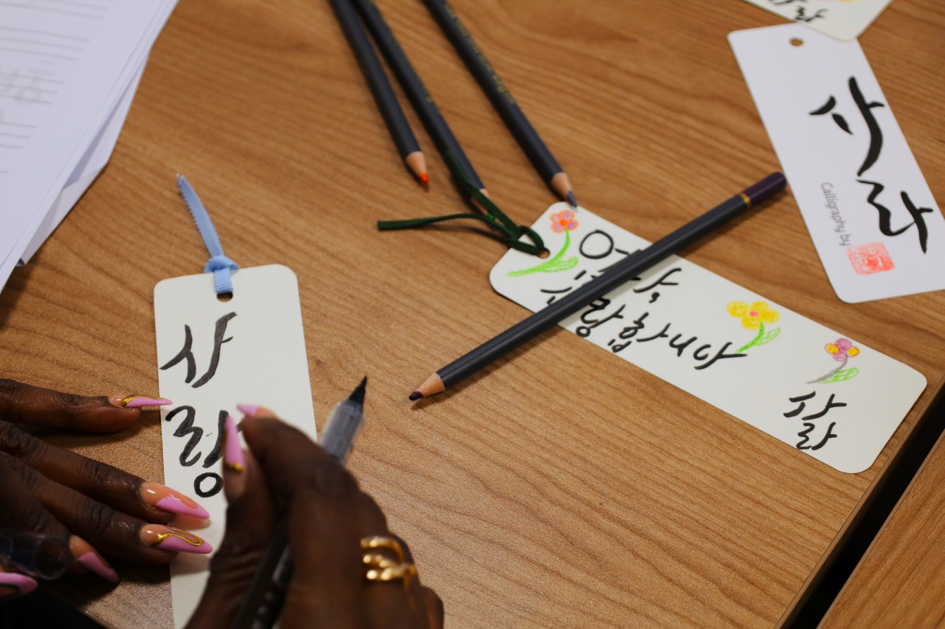 A person writing on a tag with pencils

AI-generated content may be incorrect.