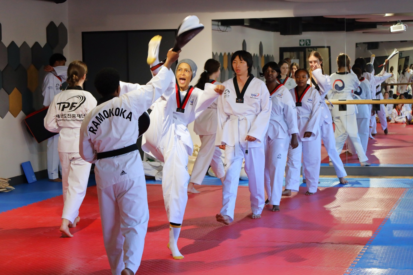A group of people in white uniforms

AI-generated content may be incorrect.