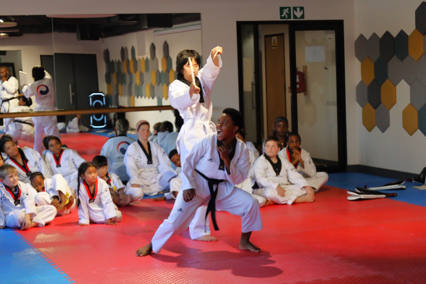 A child in a white uniform holding a stick

AI-generated content may be incorrect.