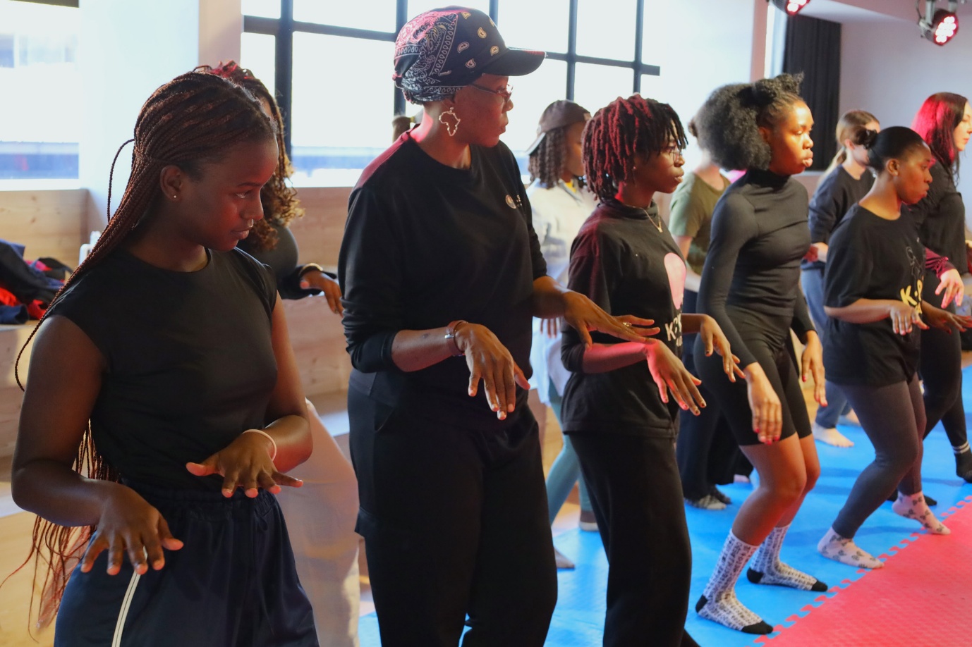 A group of women dancing

AI-generated content may be incorrect.