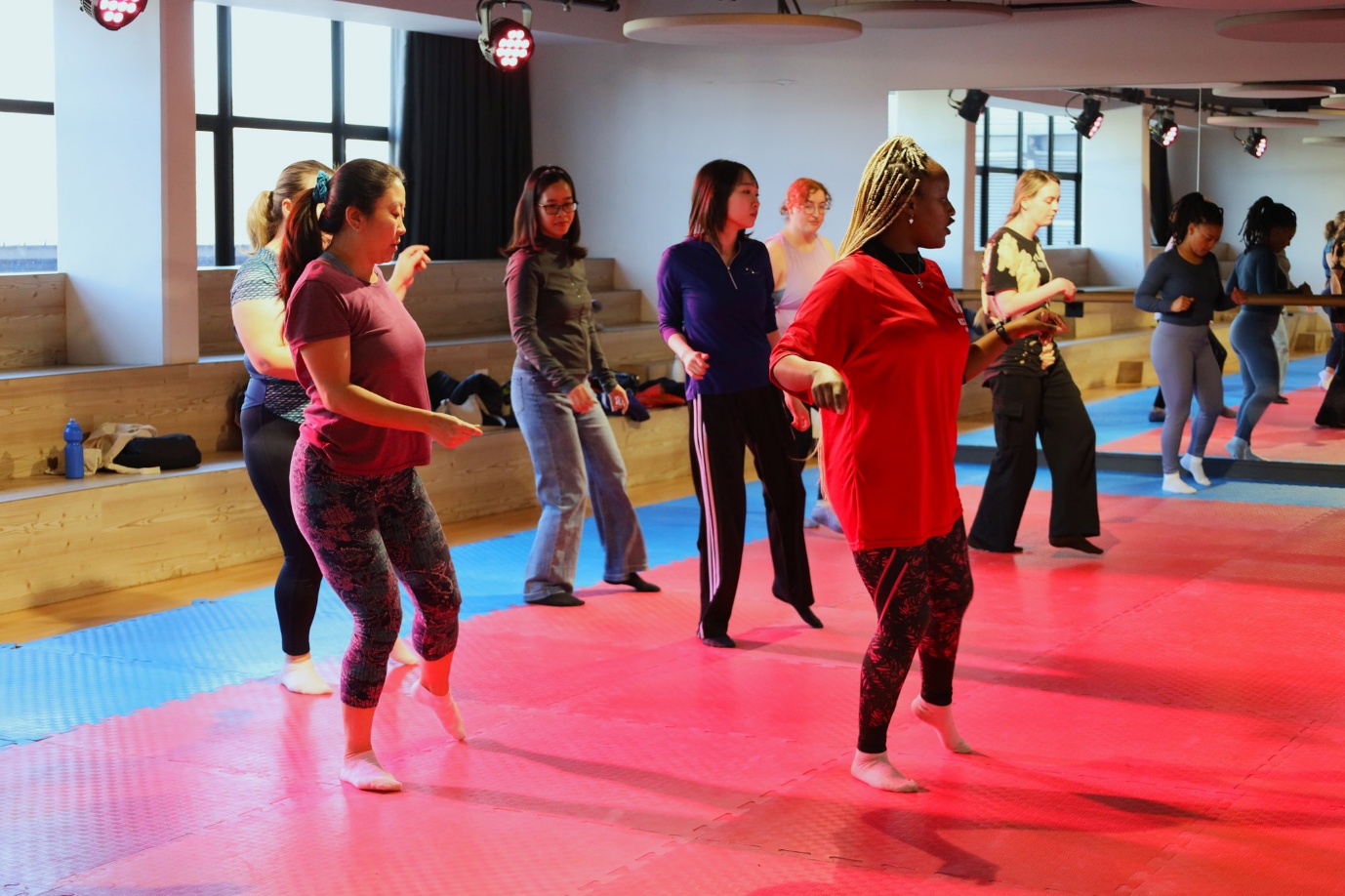 A group of people dancing in a room

AI-generated content may be incorrect.