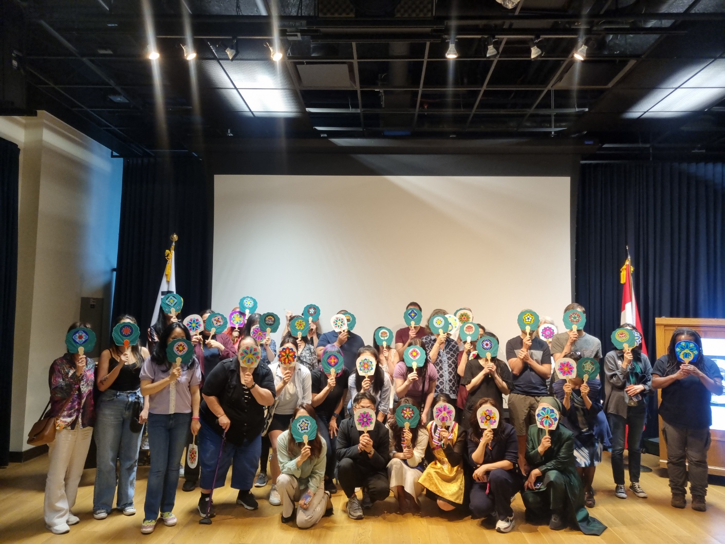 Group photo of participants holding their finished pieces