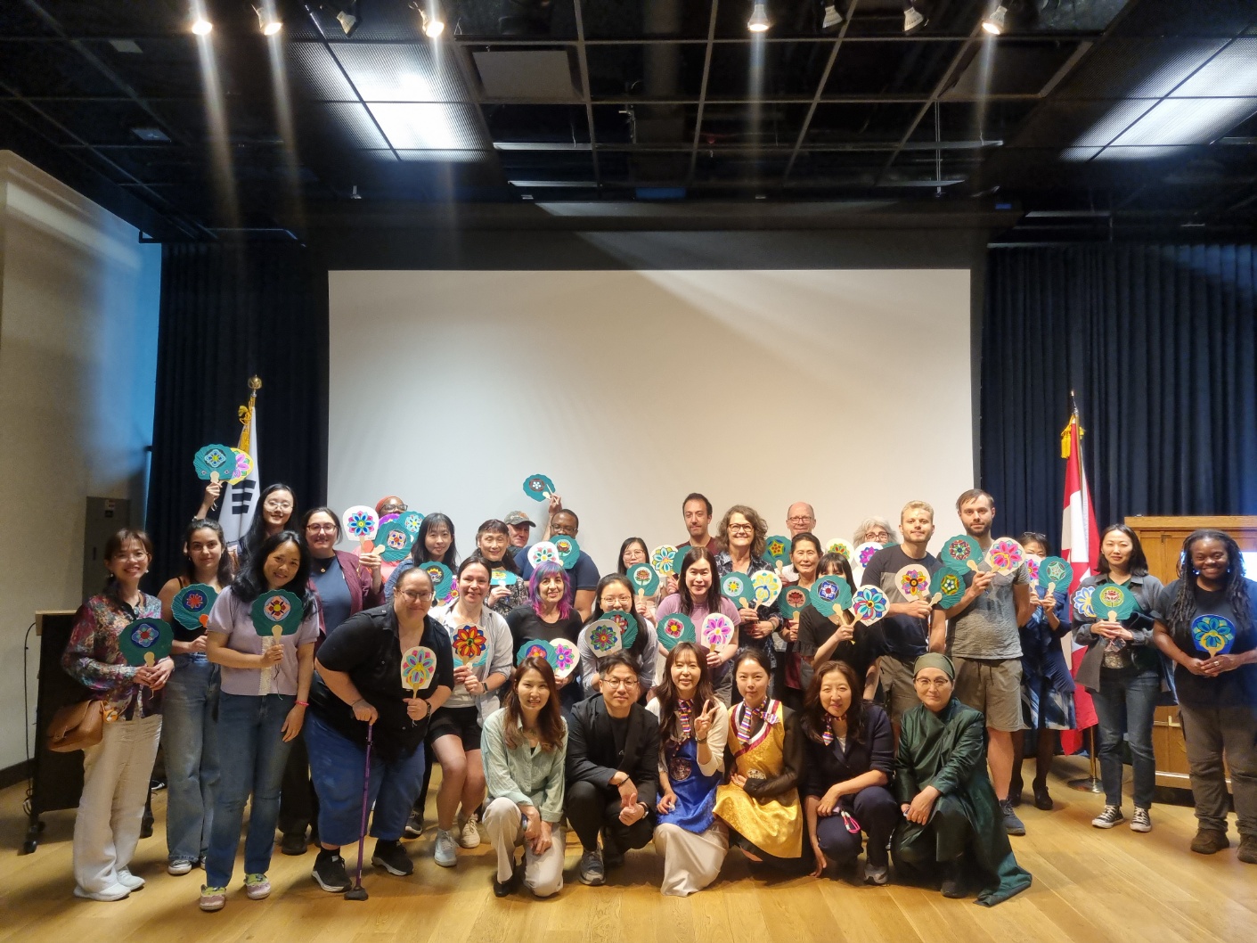 Group photo of participants holding their finished pieces