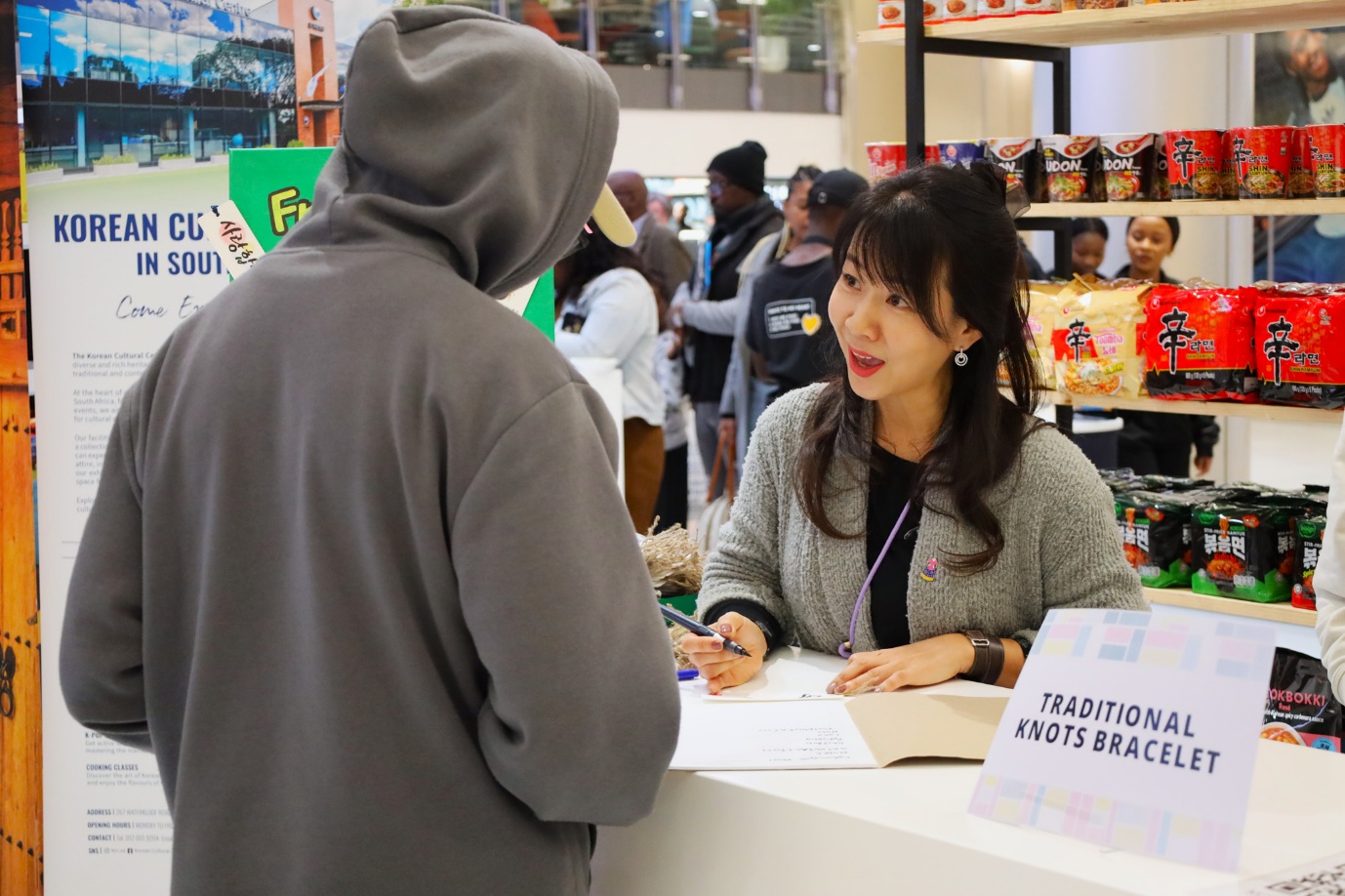 A person at a counter with a person in the background

AI-generated content may be incorrect.