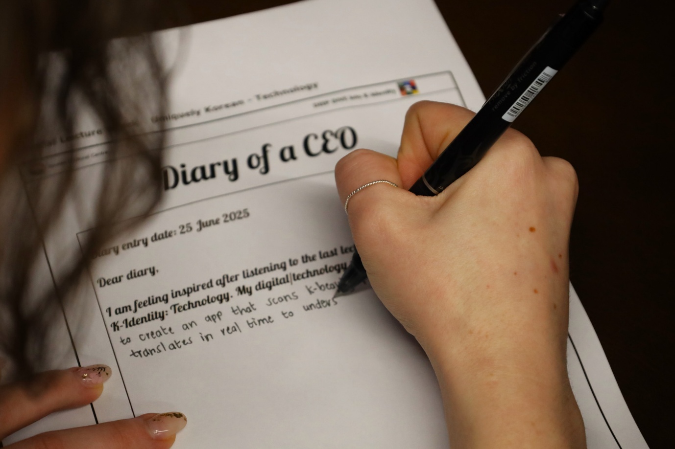 A person writing on a piece of paper

AI-generated content may be incorrect.