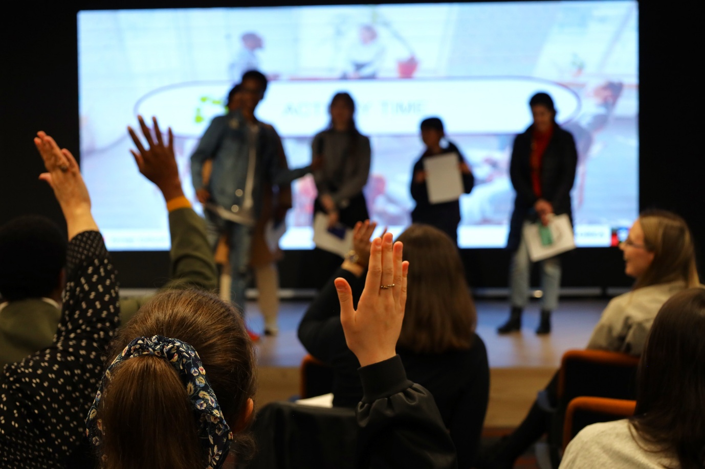 A group of people raising their hands

AI-generated content may be incorrect.