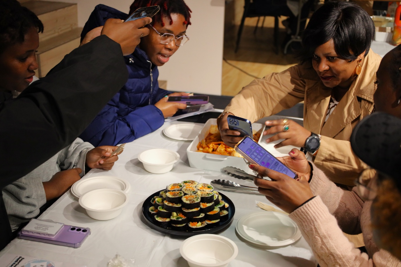 A group of people eating sushi

AI-generated content may be incorrect.