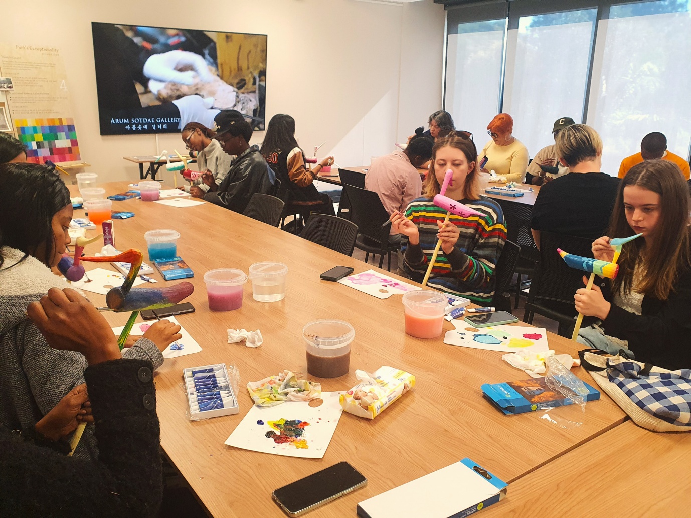 A group of people sitting at a table

AI-generated content may be incorrect.