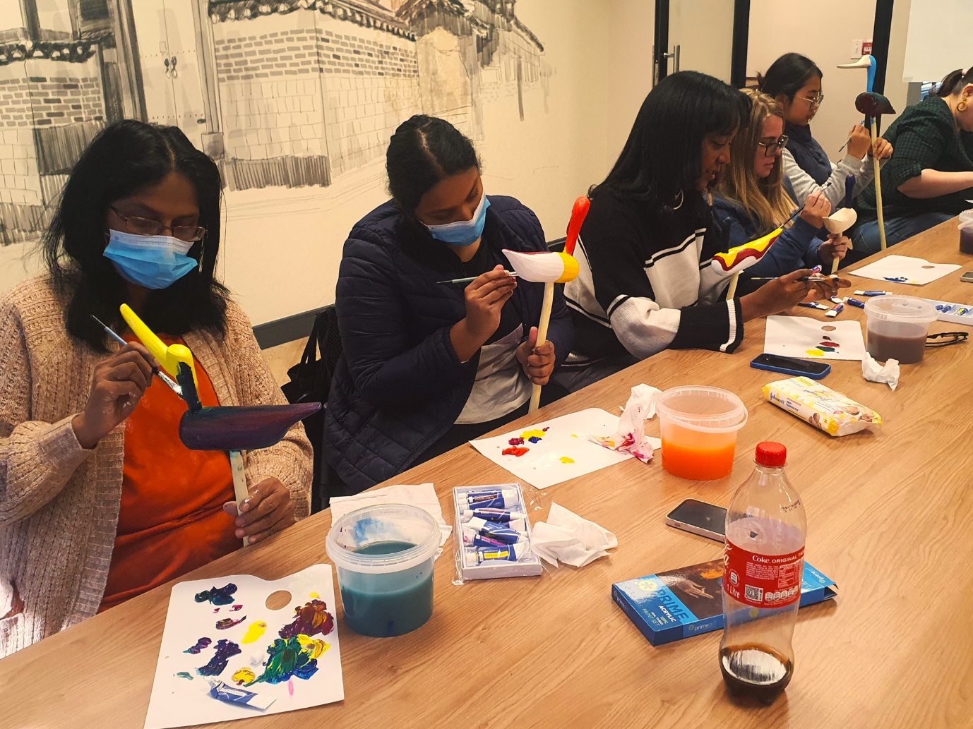 A group of people painting

AI-generated content may be incorrect.