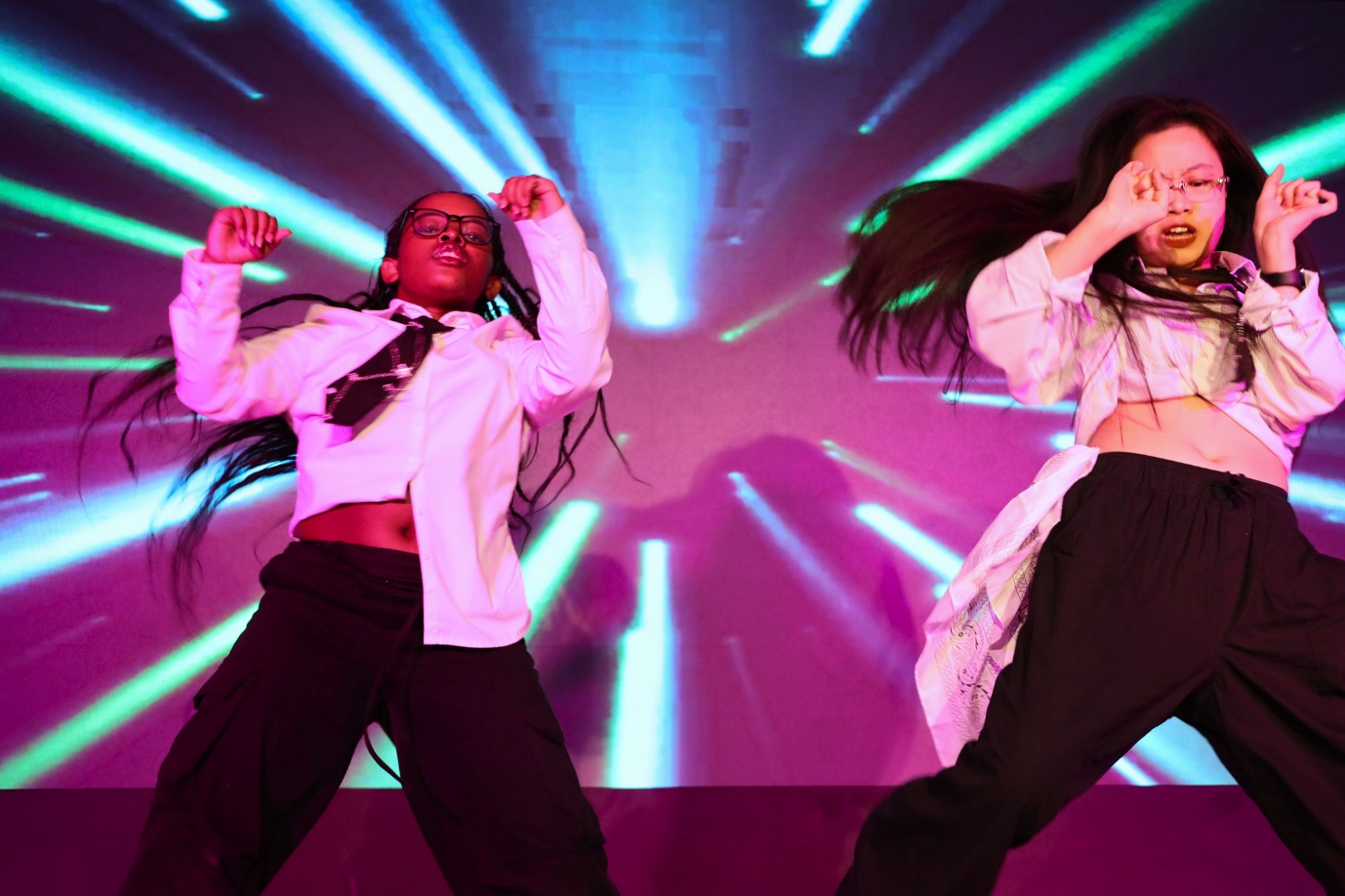 A couple of girls dancing on a stage

AI-generated content may be incorrect.
