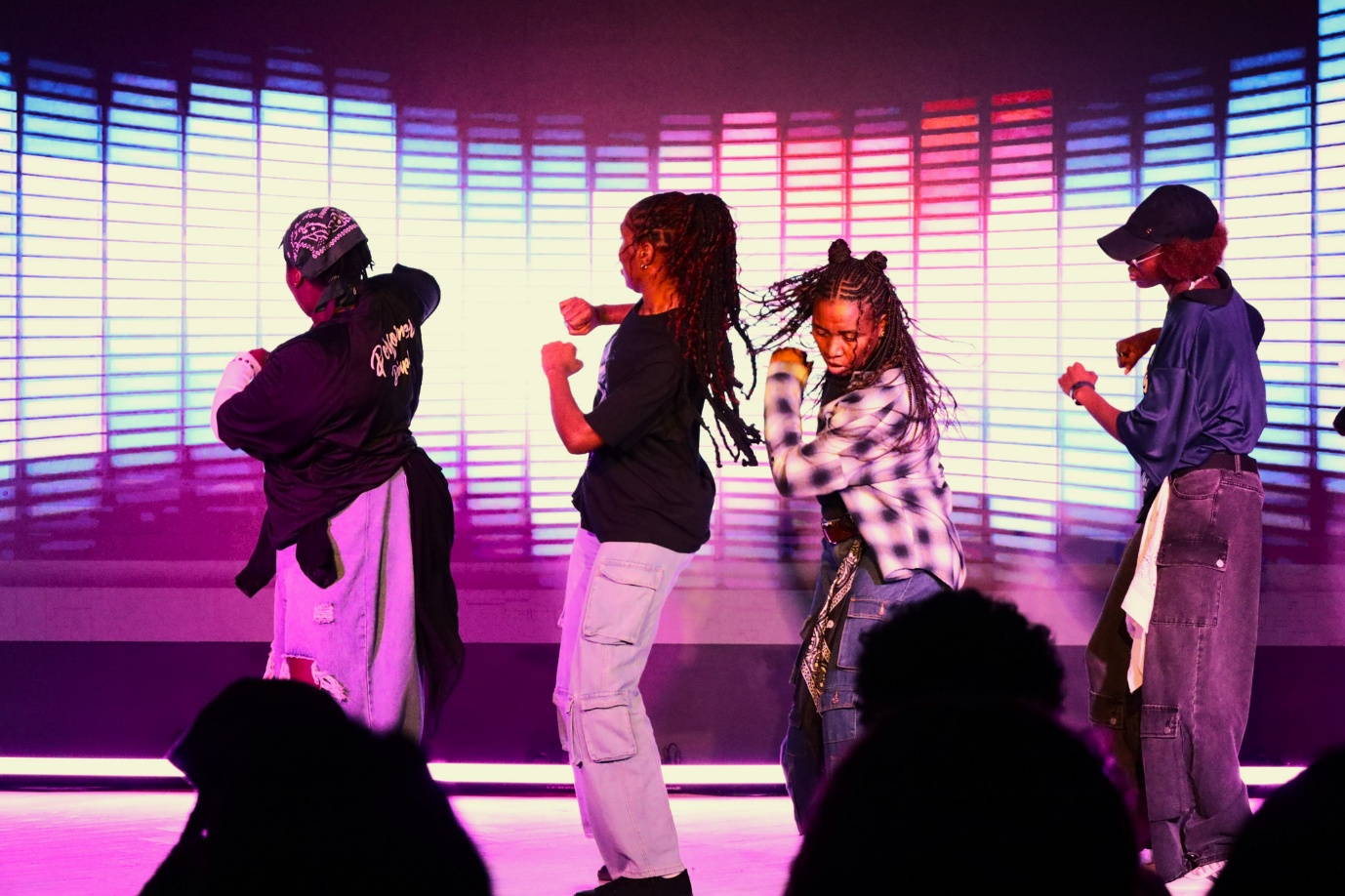 A group of people dancing on stage

AI-generated content may be incorrect.