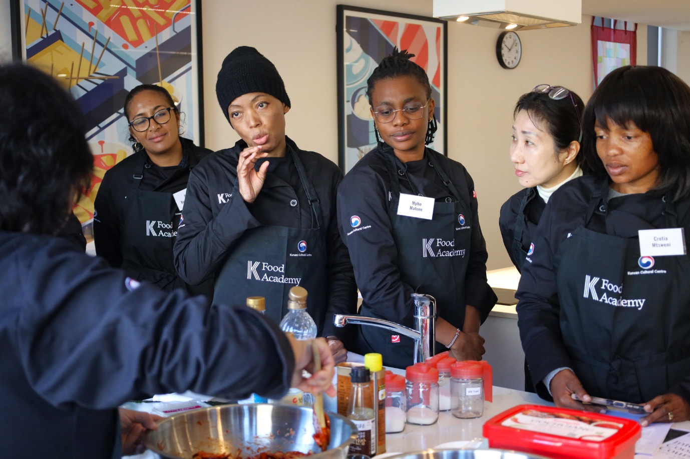 A group of women in black jackets

AI-generated content may be incorrect.