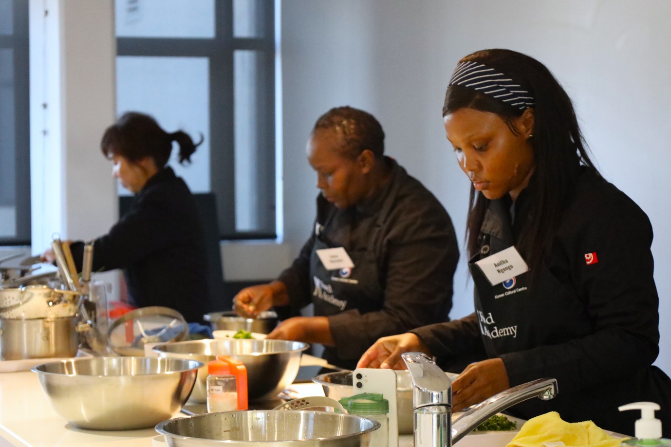 A group of people cooking in a kitchen

AI-generated content may be incorrect.