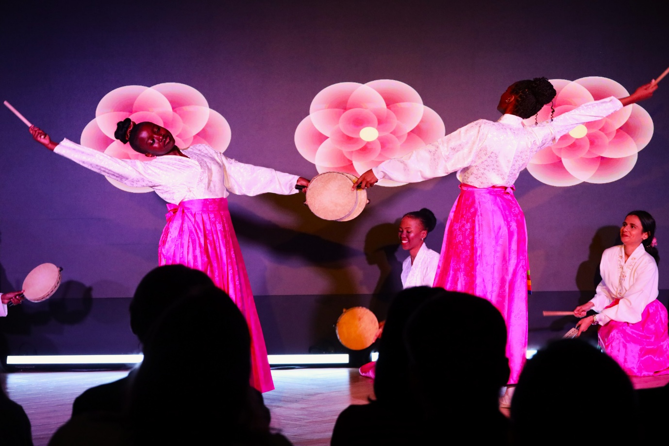 A group of women performing on stage

AI-generated content may be incorrect.