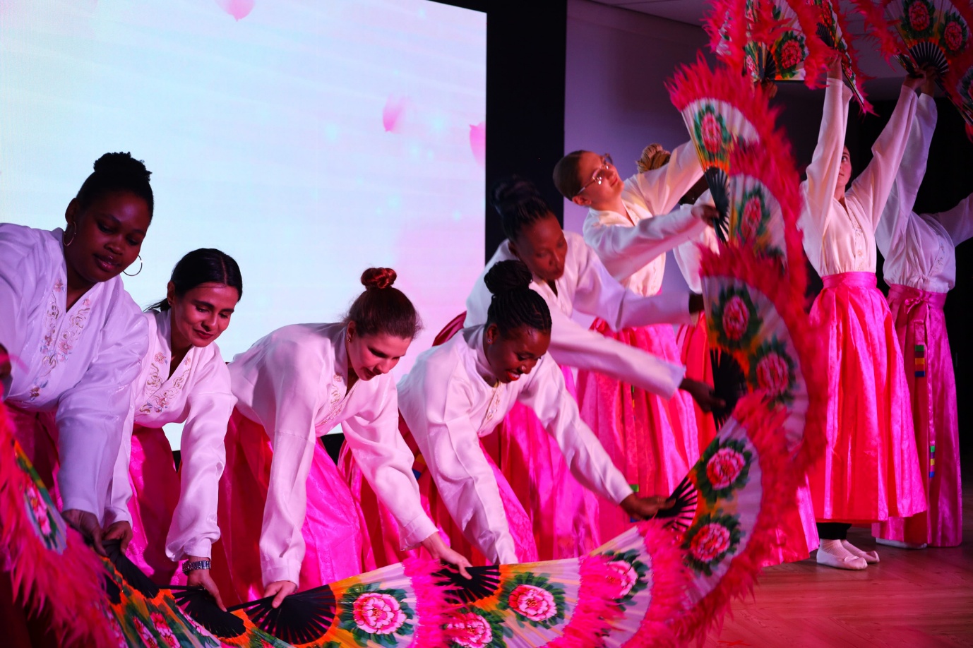 A group of women performing on stage

AI-generated content may be incorrect.