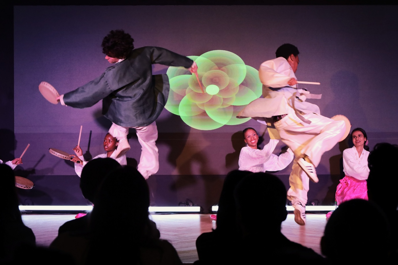 A group of people performing on stage

AI-generated content may be incorrect.