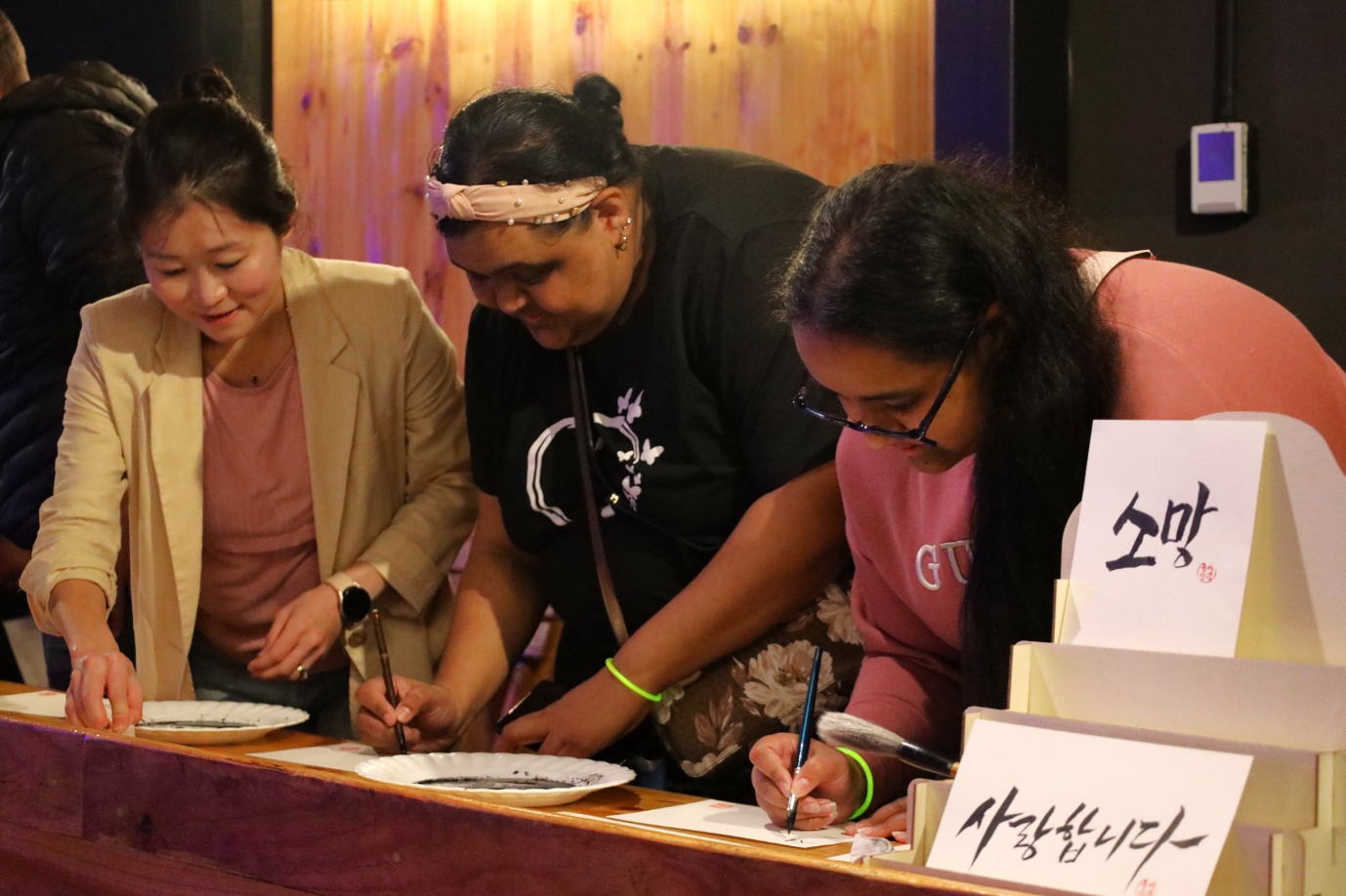 A group of women writing on paper

AI-generated content may be incorrect.
