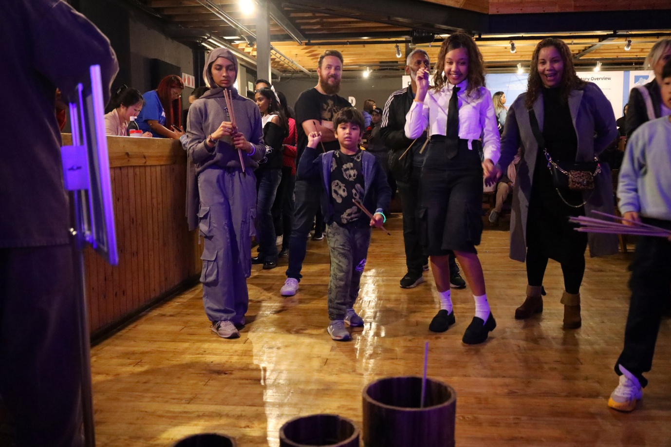 A group of people walking in a room

AI-generated content may be incorrect.