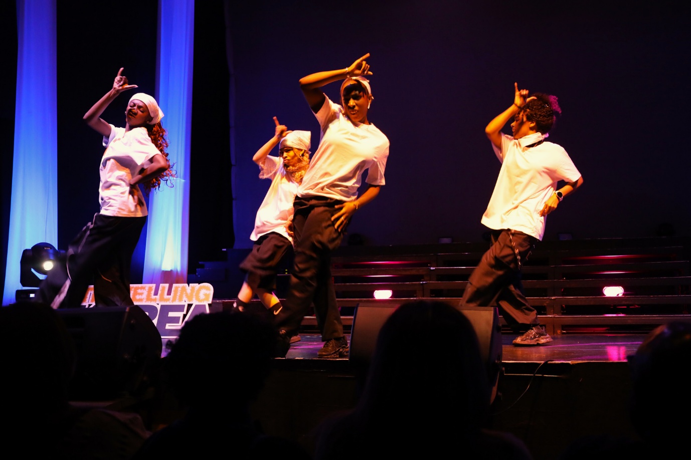 A group of people dancing on a stage

AI-generated content may be incorrect.