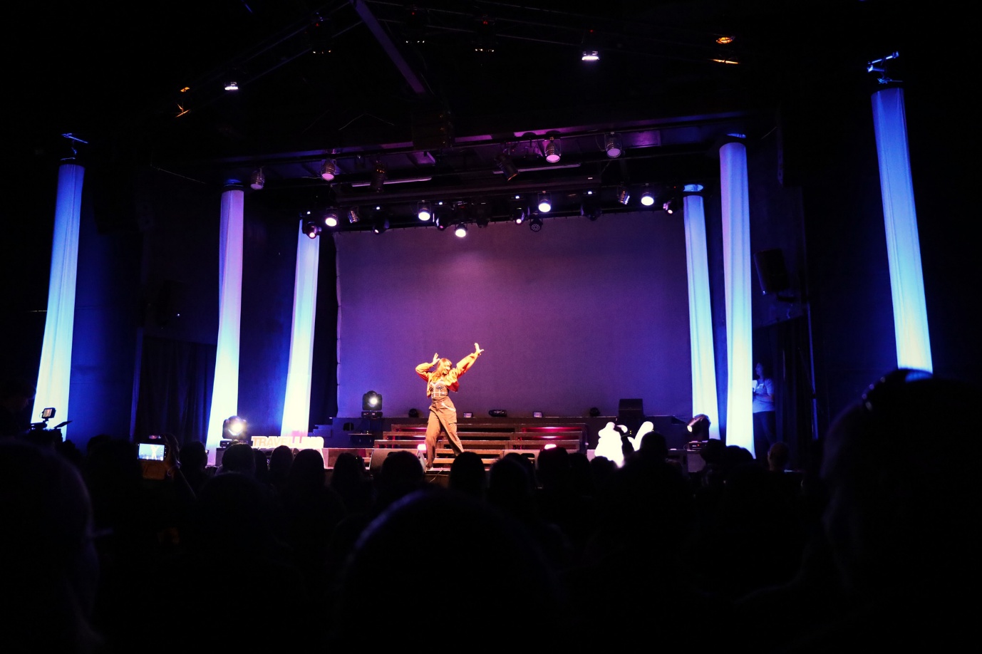 A person on a stage with a crowd watching

AI-generated content may be incorrect.