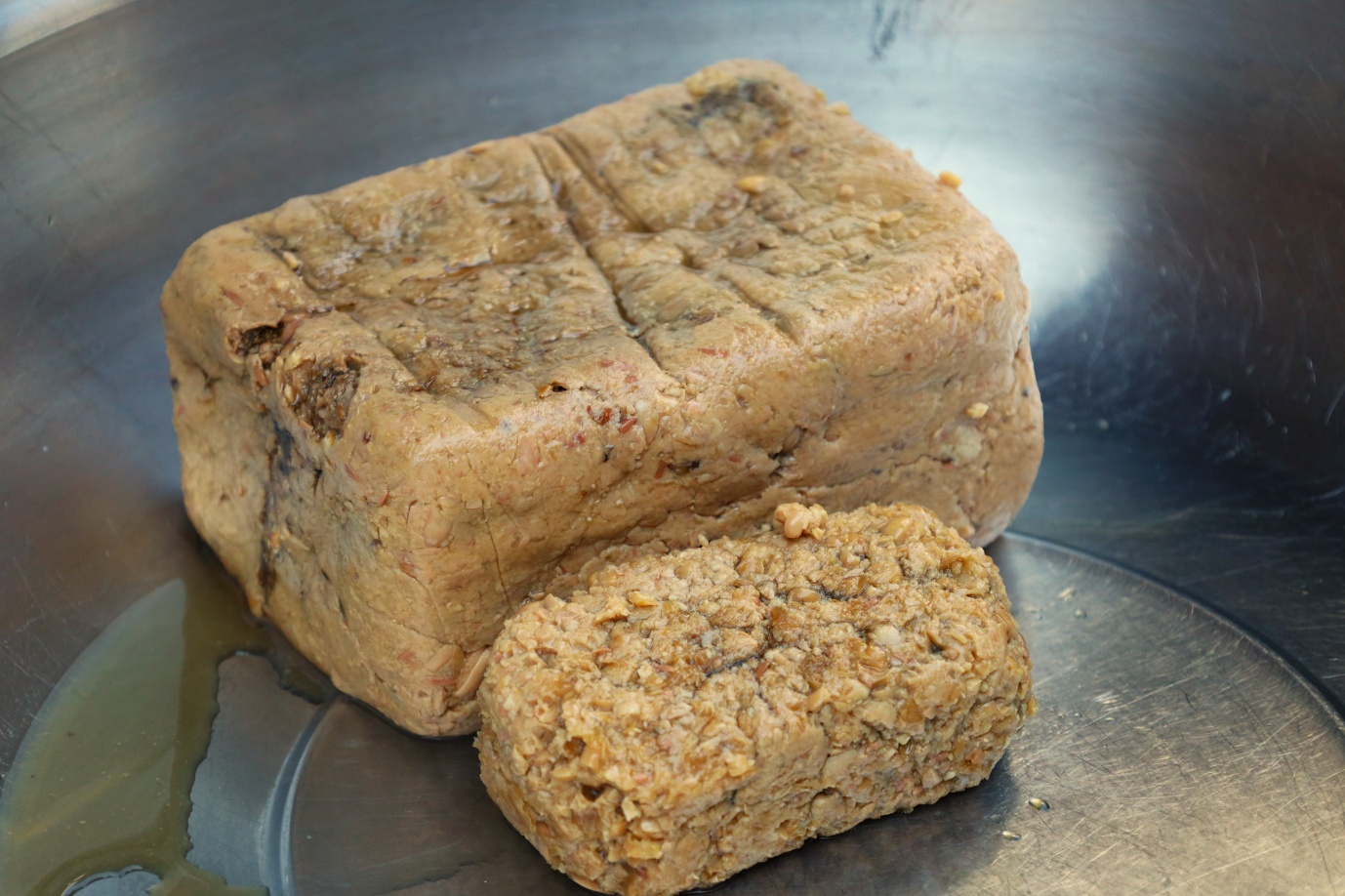 A brown rectangular object with a square object on a metal surface

AI-generated content may be incorrect.