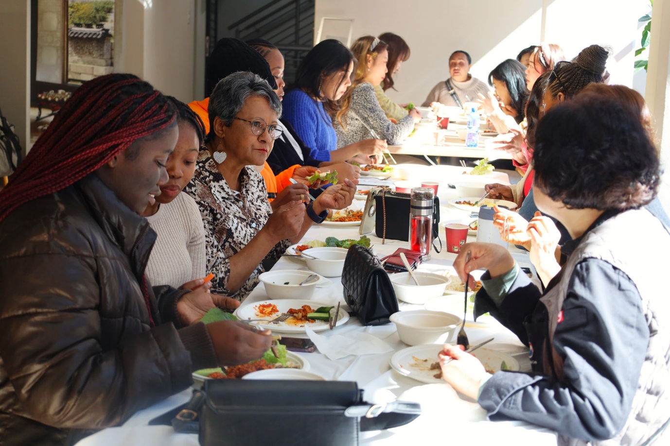 A group of people eating at a table

AI-generated content may be incorrect.