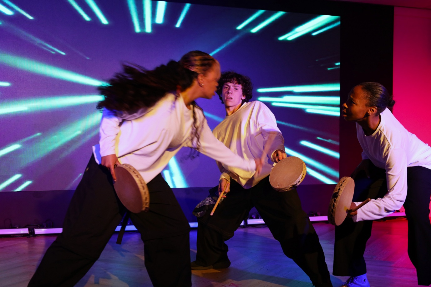 A group of people performing on stage

AI-generated content may be incorrect.