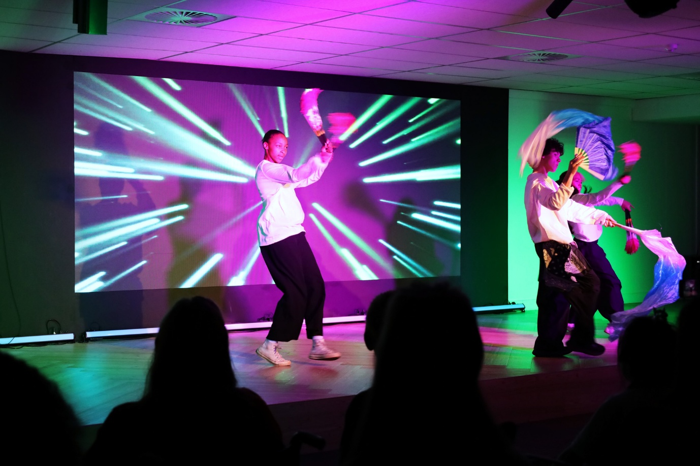 A group of people performing on stage

AI-generated content may be incorrect.